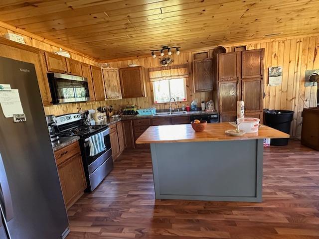 1383 Kelly Trl, Stony River Twp, MN 55607 - kitchen featuring stainless steel appliances, a center island, wood walls, dark wood-style floors, and wood ceiling