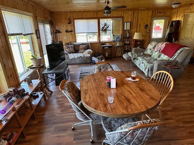 1383 Kelly Trl, Stony River Twp, MN 55607 - dining space featuring wooden walls, wood ceiling, and wood finished floors