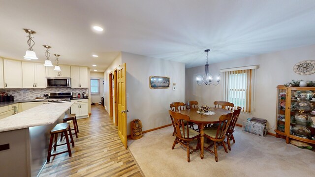 216 1st St, Kiester, MN 56051 - dining area with healthy amount of natural light, a chandelier, light wood-style flooring, and recessed lighting