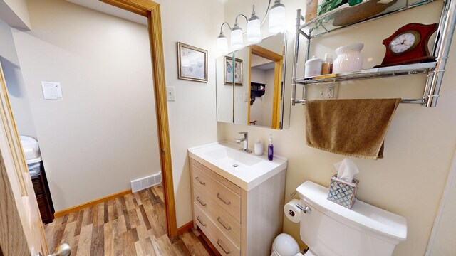 216 1st St, Kiester, MN 56051 - half bathroom featuring wood finished floors and vanity