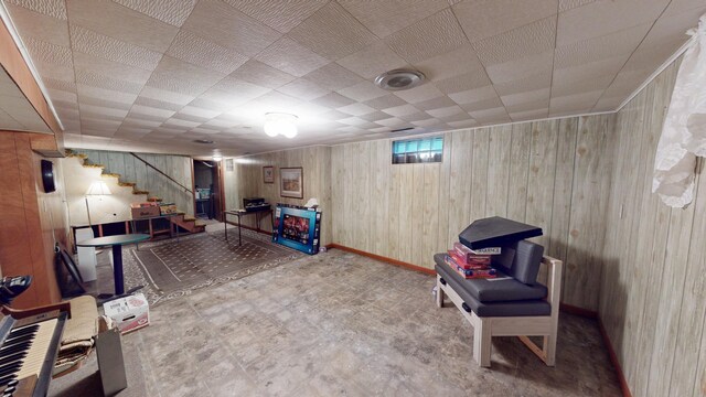 216 1st St, Kiester, MN 56051 - living area with stairway, wood walls, and tile patterned floors