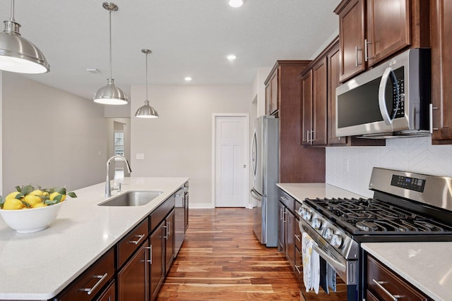 5743 Meridian Way NE, Prior Lake, MN 55372 - kitchen featuring appliances with stainless steel finishes, light wood finished floors, backsplash, pendant lighting, and recessed lighting