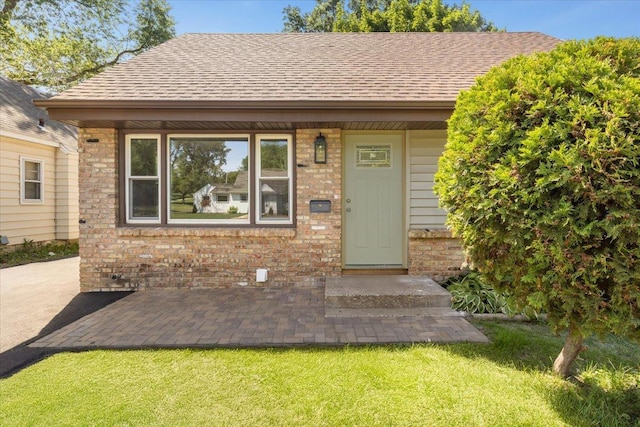 422 Jefferson Ave S, Edina, MN 55343 - view of front of home with brick siding, a front yard, and roof with shingles