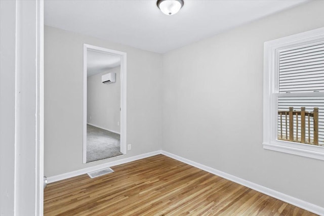 422 Jefferson Ave S, Edina, MN 55343 - empty room featuring a wall mounted AC and wood finished floors