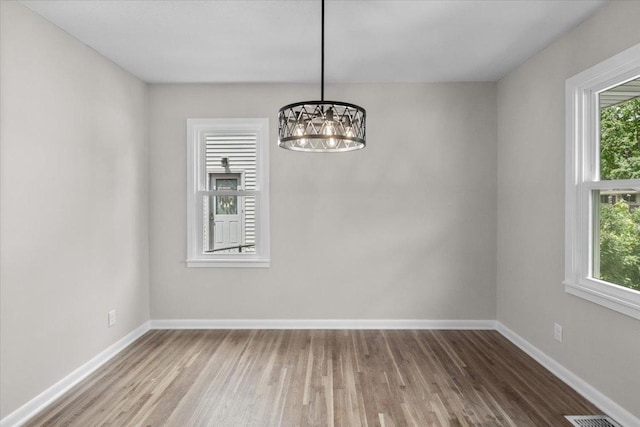 422 Jefferson Ave S, Edina, MN 55343 - unfurnished dining area featuring a chandelier and wood finished floors