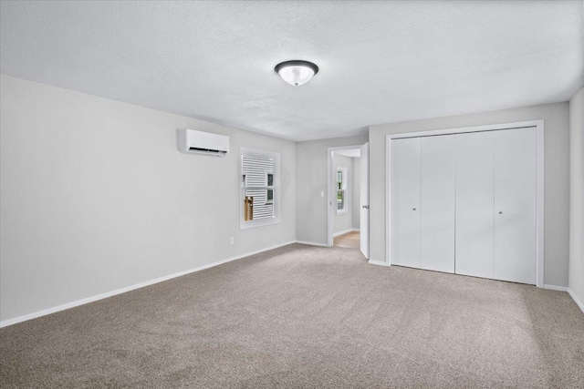 422 Jefferson Ave S, Edina, MN 55343 - unfurnished bedroom featuring a wall mounted air conditioner, carpet flooring, a closet, and a textured ceiling