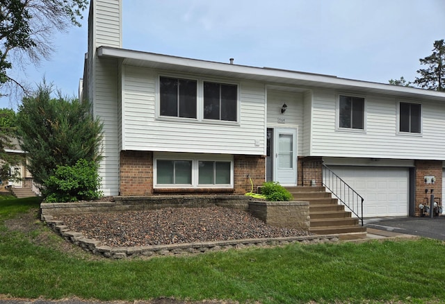 564 98th Ln NE, Blaine, MN 55434 - raised ranch with an attached garage, brick siding, a chimney, and asphalt driveway