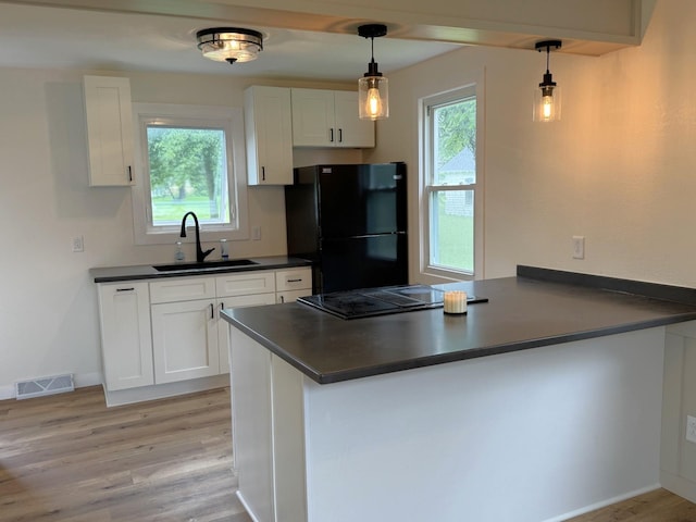 251 Colfax Ave NE, Hector, MN 55342 - kitchen featuring black appliances, dark countertops, a peninsula, and light wood-style flooring
