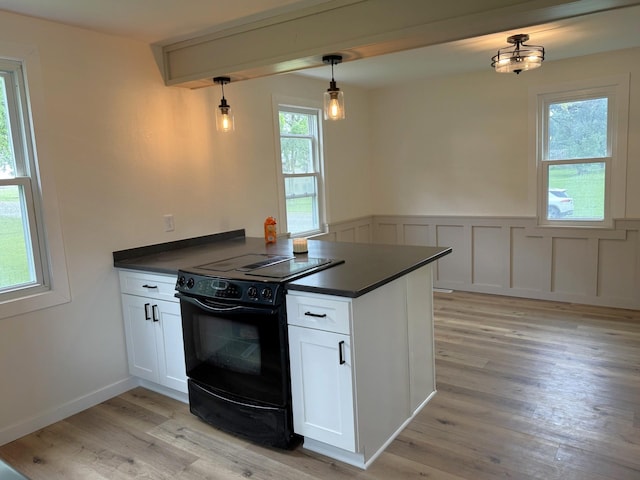 251 Colfax Ave NE, Hector, MN 55342 - kitchen featuring black range with electric stovetop, dark countertops, light wood-style floors, a peninsula, and white cabinetry