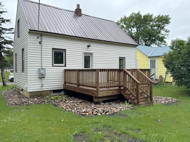 251 Colfax Ave NE, Hector, MN 55342 - back of property with a wooden deck, a yard, and a chimney