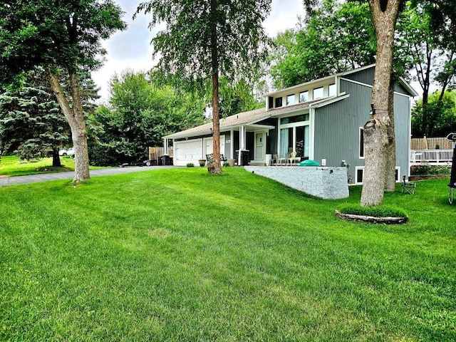 904 155th St, Burnsville, MN 55306 - view of front facade featuring a garage, a front yard, and asphalt driveway