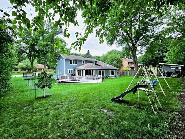 904 155th St, Burnsville, MN 55306 - back of property featuring a playground, a deck, and a shingled roof