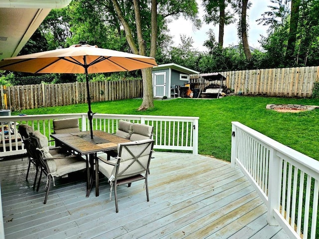 904 155th St, Burnsville, MN 55306 - deck with outdoor dining space, a fenced backyard, and a storage unit