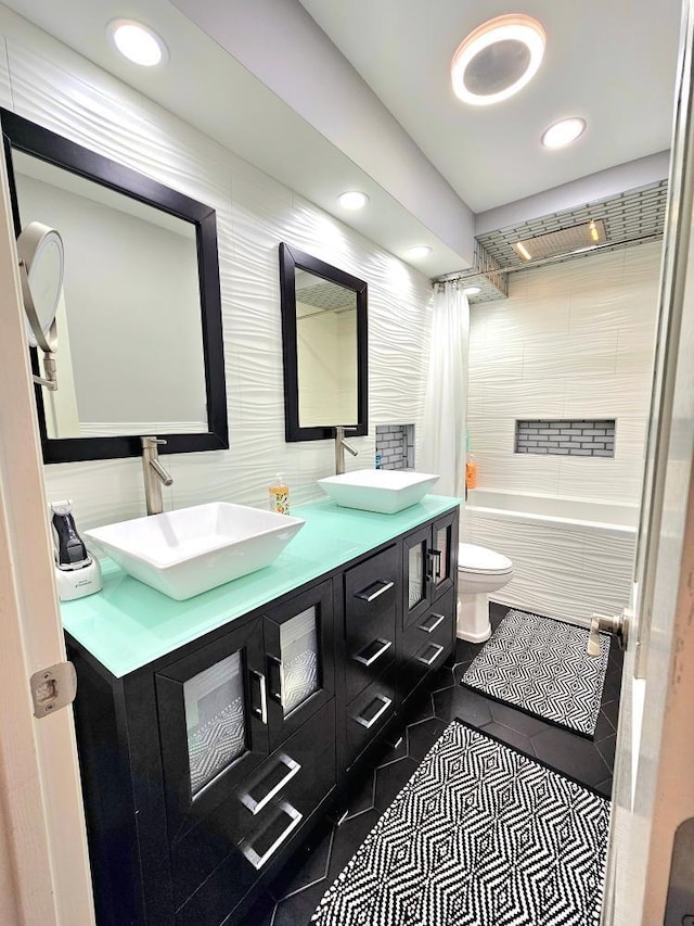 904 155th St, Burnsville, MN 55306 - bathroom with double vanity, shower / bath combo, tile patterned floors, recessed lighting, and tile walls