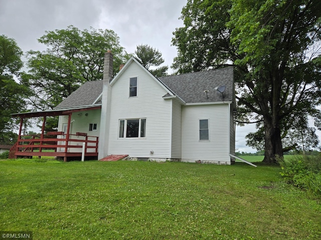 1264 389th Ave NE, Stanchfield Twp, MN 55080 - rear view of property with a shingled roof, a deck, a chimney, and a yard