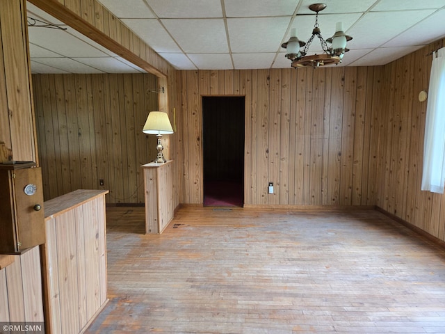 1264 389th Ave NE, Stanchfield Twp, MN 55080 - unfurnished room featuring a paneled ceiling, hardwood / wood-style flooring, a chandelier, and wood walls
