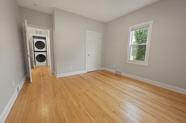 730 13th Ave S, Saint Cloud, MN 56301 - unfurnished bedroom featuring stacked washer / dryer and light wood-style flooring