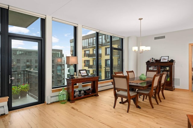 1120 2nd St Unit 1002, Minneapolis, MN 55415 - dining area featuring a chandelier, wood finished floors, healthy amount of natural light, and a wall of windows