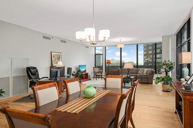 1120 2nd St Unit 1002, Minneapolis, MN 55415 - dining area featuring a chandelier, light wood-type flooring, an office area, and a wall of windows
