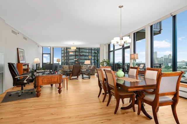 1120 2nd St Unit 1002, Minneapolis, MN 55415 - dining area featuring light wood-style flooring, floor to ceiling windows, an office area, a chandelier, and healthy amount of natural light