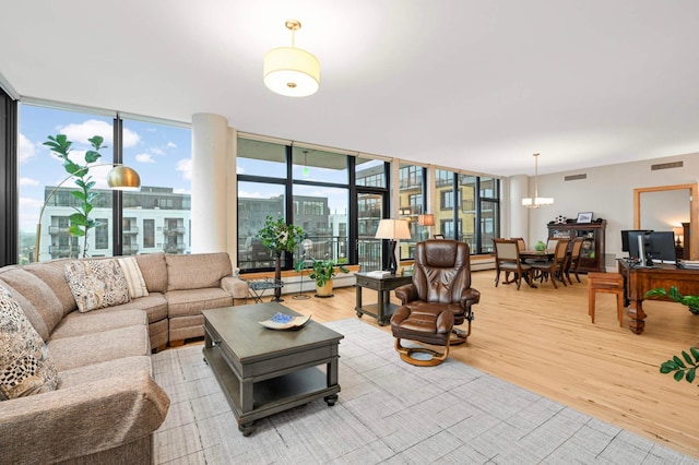 1120 2nd St Unit 1002, Minneapolis, MN 55415 - living room featuring light wood-style floors, floor to ceiling windows, and a chandelier