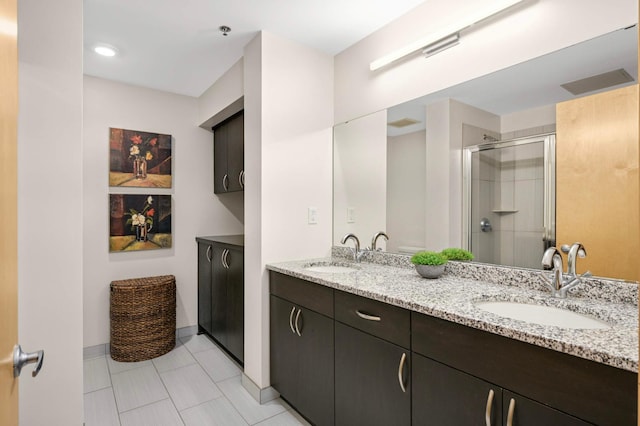 1120 2nd St Unit 1002, Minneapolis, MN 55415 - full bath with double vanity, a shower stall, and tile patterned flooring