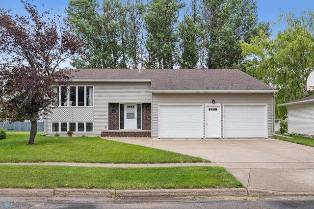 611 4th St NE, Dilworth, MN 56529 - view of front of house featuring concrete driveway, an attached garage, a front lawn, and brick siding