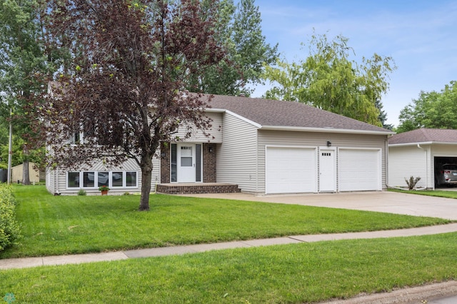 611 4th St NE, Dilworth, MN 56529 - view of front of property featuring an attached garage, driveway, a front lawn, and roof with shingles