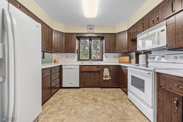 611 4th St NE, Dilworth, MN 56529 - kitchen featuring white appliances, a textured ceiling, light countertops, backsplash, and dark brown cabinets