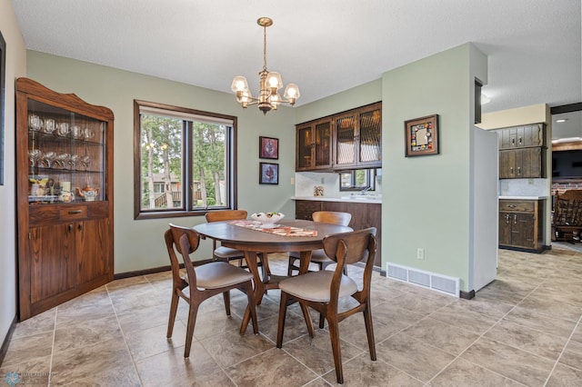 611 4th St NE, Dilworth, MN 56529 - dining room with a chandelier and a textured ceiling