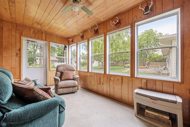 611 4th St NE, Dilworth, MN 56529 - sunroom / solarium featuring wood walls, a ceiling fan, wooden ceiling, and carpet
