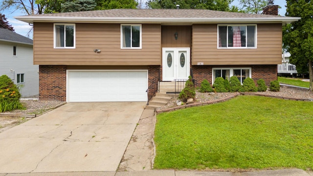 2735 Chisholm Ave N, Saint Paul, MN 55109 - bi-level home featuring brick siding, a garage, a chimney, a front yard, and driveway
