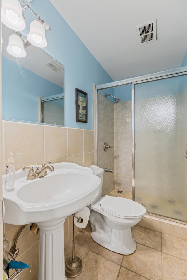2735 Chisholm Ave N, Saint Paul, MN 55109 - bathroom with a stall shower, tile patterned flooring, and tile walls