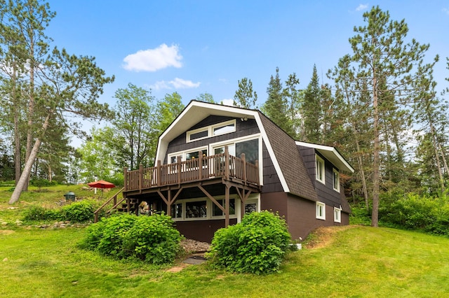 6618 Sumac Dr, Grand Lake Twp, MN 55803 - rear view of property featuring a gambrel roof, a wooden deck, and a yard