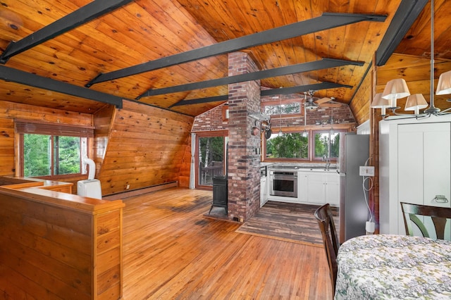 6618 Sumac Dr, Grand Lake Twp, MN 55803 - kitchen with stainless steel appliances, a baseboard heating unit, light wood-style floors, a wood ceiling with exposed beams, and white cabinetry