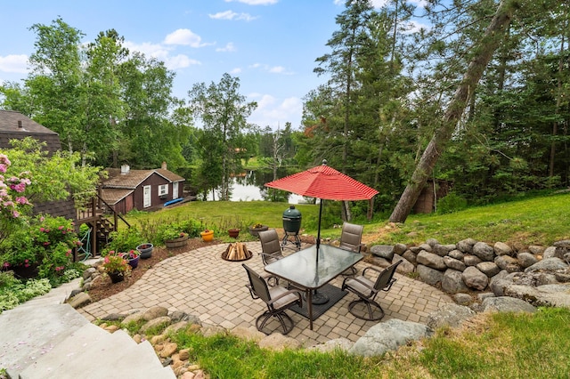 6618 Sumac Dr, Grand Lake Twp, MN 55803 - view of patio / terrace with a water view, outdoor dining space, and an outbuilding