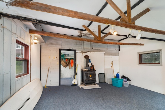 6618 Sumac Dr, Grand Lake Twp, MN 55803 - garage with a wood stove, a wall unit AC, baseboard heating, and wood walls