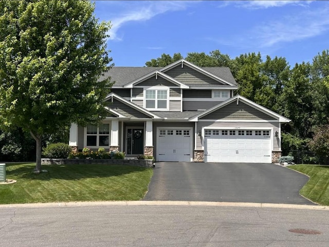 12372 73rd Ct NE, Otsego, MN 55330 - craftsman house with driveway, a front yard, stone siding, and a shingled roof