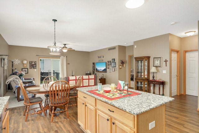 9775 Olive St NW, Coon Rapids, MN 55433 - kitchen with wood finished floors, a center island, light brown cabinets, decorative light fixtures, and a ceiling fan