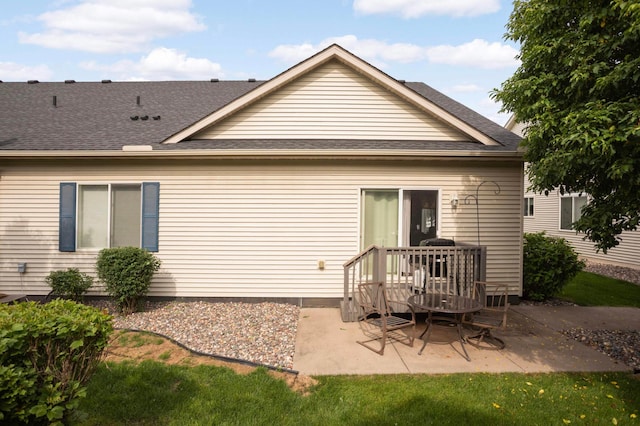 9775 Olive St NW, Coon Rapids, MN 55433 - rear view of house with a patio and roof with shingles