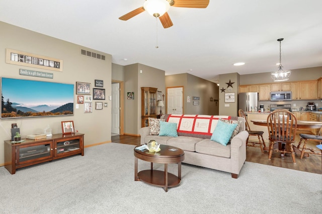 9775 Olive St NW, Coon Rapids, MN 55433 - carpeted living area with ceiling fan and baseboards