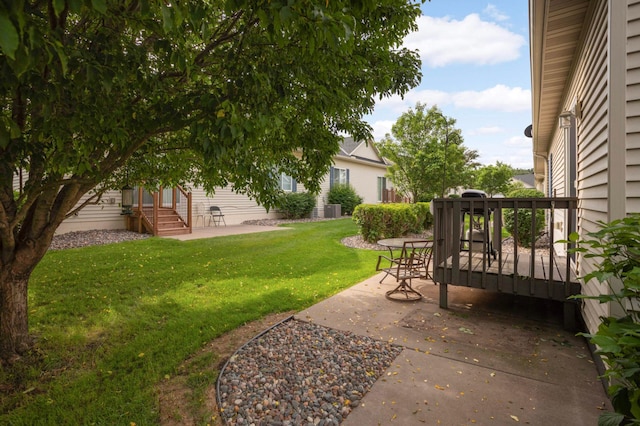 9775 Olive St NW, Coon Rapids, MN 55433 - view of grassy yard featuring a patio area and a wooden deck