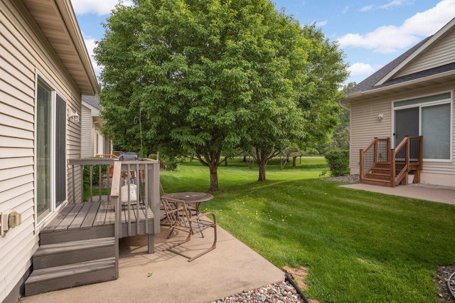 9775 Olive St NW, Coon Rapids, MN 55433 - view of grassy yard featuring a deck and a patio area