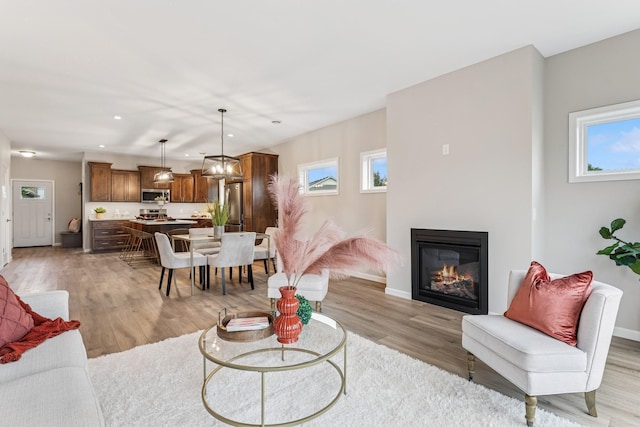 4838 Education Dr N, Hugo, MN 55038 - living area featuring light wood finished floors, recessed lighting, and a glass covered fireplace