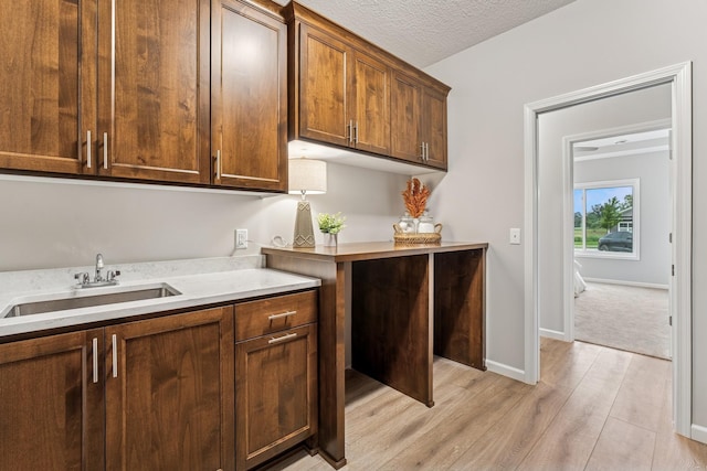4838 Education Dr N, Hugo, MN 55038 - kitchen with light wood-type flooring, light countertops, and a textured ceiling