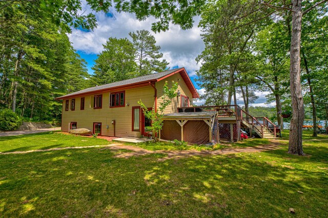 10399 Sandy Beach Rd, Round Lake Twp, WI 54843 - rear view of property featuring stairway, a deck, and a lawn