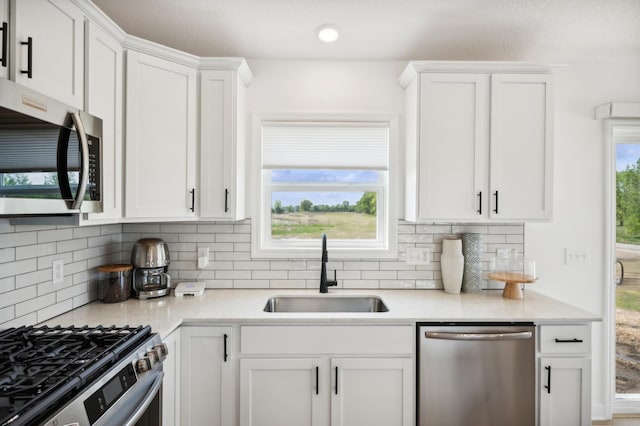 26645 8th St W, Zimmerman, MN 55398 - kitchen with stainless steel appliances, white cabinetry, and decorative backsplash