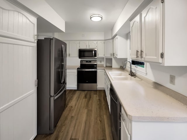 5808 Colfax Ave N, Brooklyn Center, MN 55430 - kitchen featuring appliances with stainless steel finishes, white cabinetry, light countertops, and dark wood-style floors