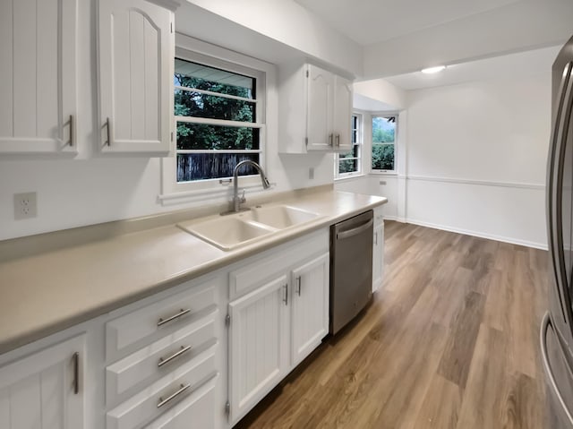 5808 Colfax Ave N, Brooklyn Center, MN 55430 - kitchen featuring stainless steel appliances, light countertops, white cabinets, and wood finished floors