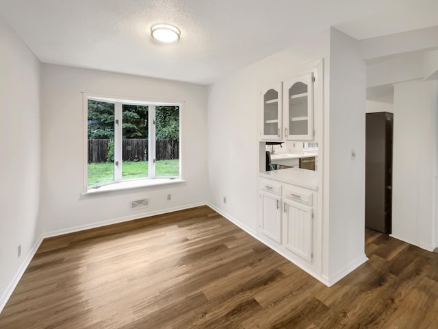 5808 Colfax Ave N, Brooklyn Center, MN 55430 - unfurnished dining area featuring dark wood-style flooring and baseboards